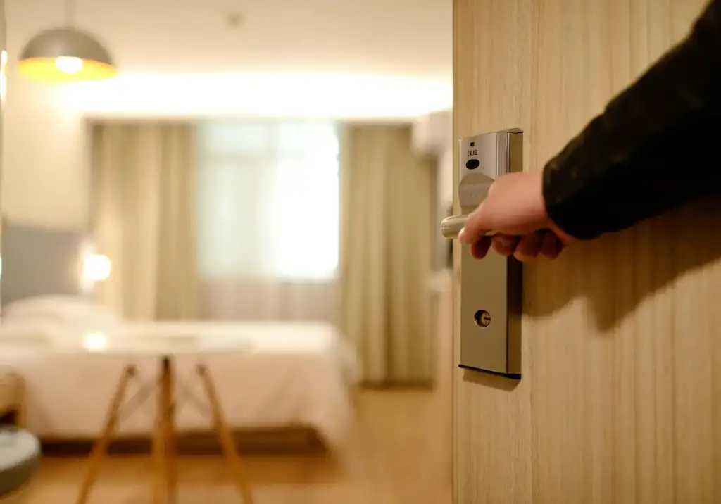 A guest opening the door to a vacation rental, ready to enjoy a comfortable stay.