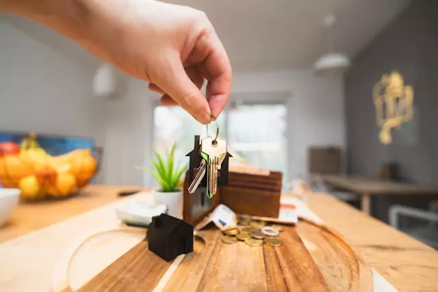 person placing keys on a tabe