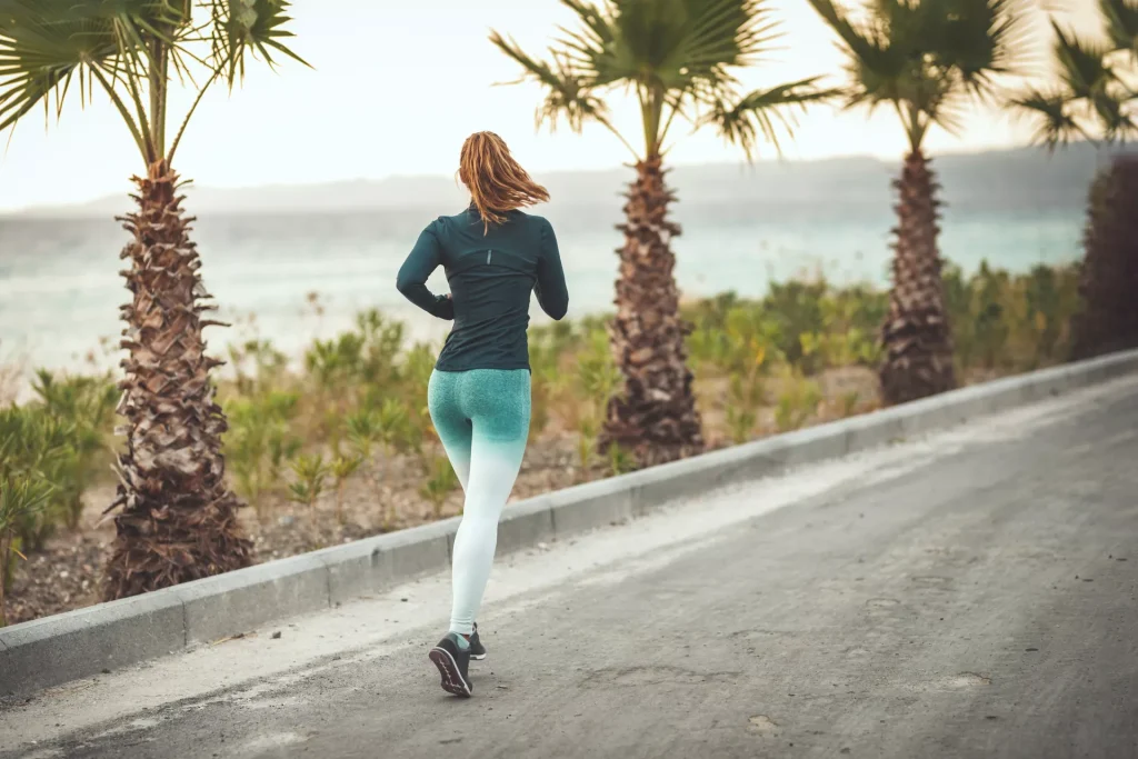 woman running near ocean