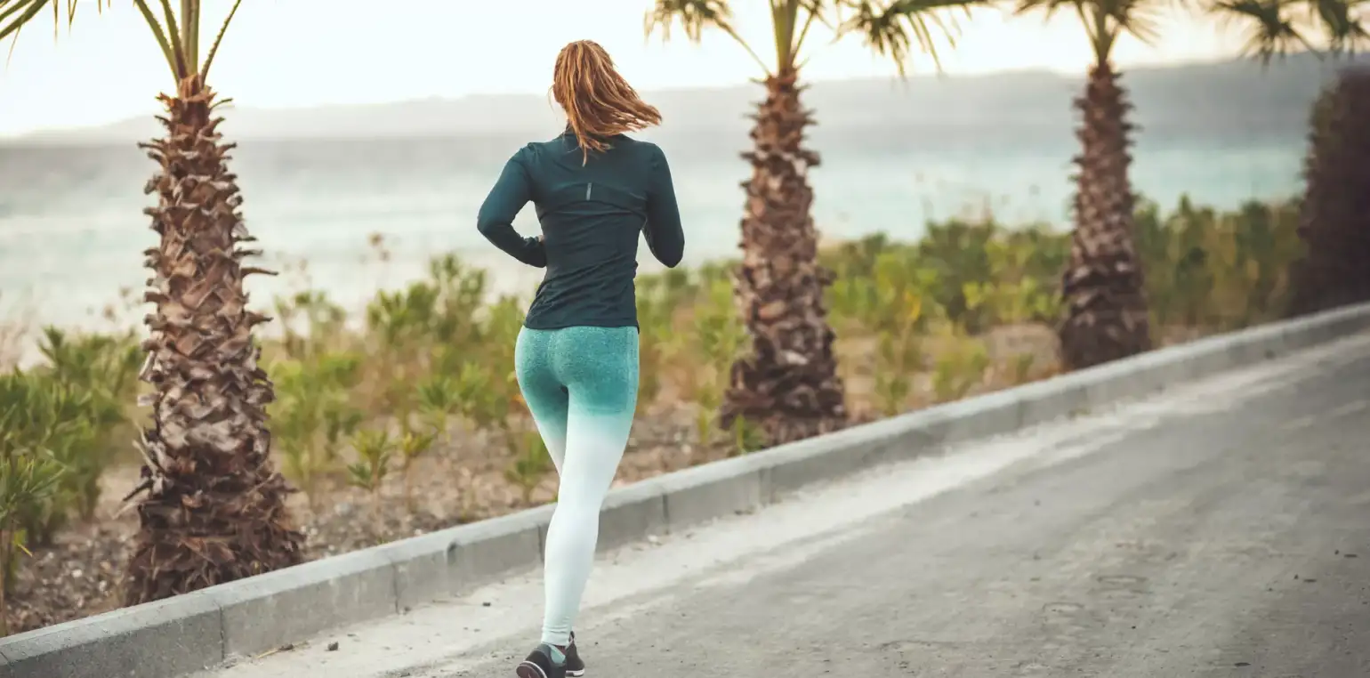 woman running near ocean